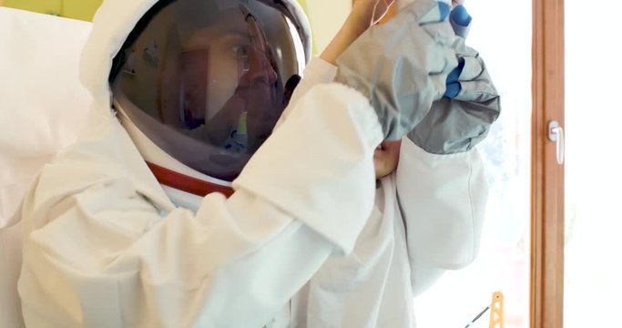 Father and kid playing with astronaut costume at home