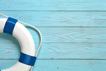 Sea lifebuoy on blue wooden background .