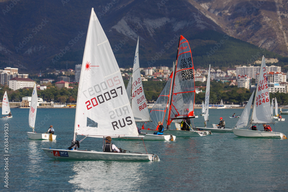 Wall mural the resort of gelendzhik. annual children's yacht regatta. many yachts with white sails in gelendzhi