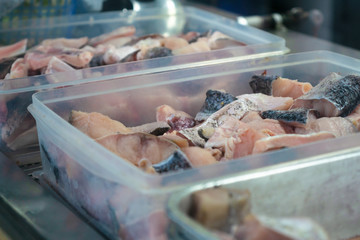 Sea food cooking preparation, slice of fresh delicious raw snapper fish in container boxes for asian food cooking. Close up selective focus.