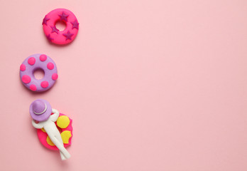 Plasticine people relaxing on inflatable donut lilo in pool. Cartoon summer relaxing and holidays.