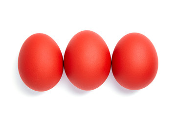 Three red Easter eggs isolated on white background. Traditional symbol of Christian holiday