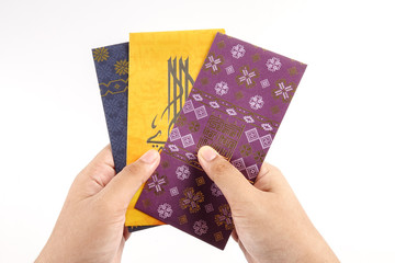 Money packet during Eid Fitr on white. Arabic characters means Happy Eid Mubarak. - 263445767