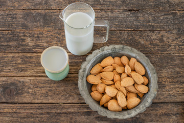 Almond milk with shelled almonds on the table