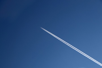 Inversion trail from an airplane in the clear blue sky