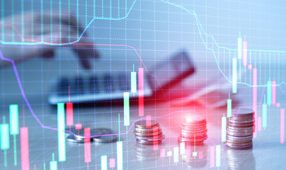 Financial graph chart and rows of coins with calculator.