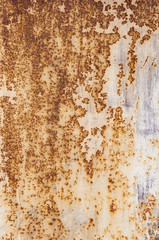 Background textures of old rusty damaged metal. Remains of multi-colored paint on an iron sheet.