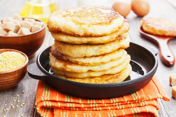 Millet pancakes in a frying pan