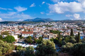 Obraz premium Rethymnon, Crete, Greece - August 15, 2015: view from the fortress of Fortezza to the city of Rethymnon. Roofs of houses and mountains