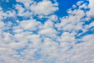 Gloomy white fluffy clouds on a blue sky_