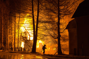 Firefighter fighting housefire