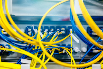 Network hub and patch UTP LAN cables in rack cabinet, close up