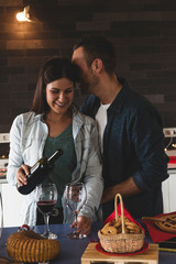 young couple of lovers celebrating at home drinking wine