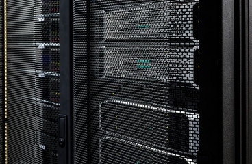 Close up server racks in modern data center background