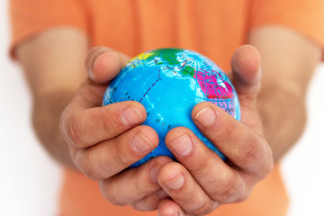 Hand of the person holds globe