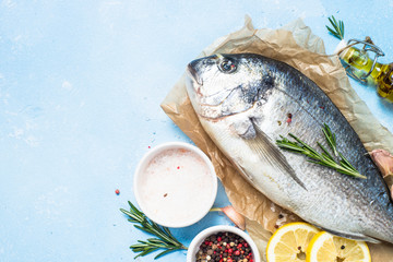 Fresh fish dorado on blue background.