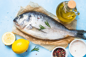 Fresh fish dorado on blue background.