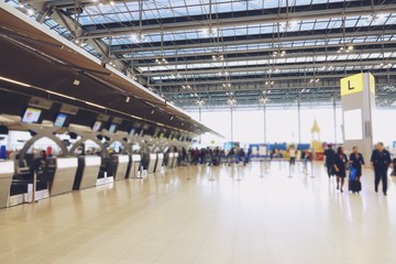 Naklejka premium blurred airport check in desk counter gate with weighting luggage belt