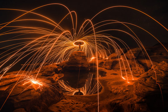 Burning steel wool on the rock near the river at Sam Phan Bok in Ubonratchathani unseen in Thailand. The Grand Canyon of Thailand.