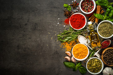 Set of various spices on black background.