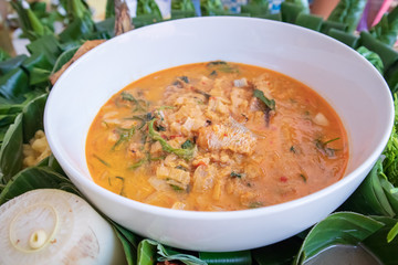Traditional Thai kaeng phet red curry  in a bowl on a banana leaf