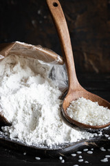 White rice flour in a crafting bag on a dark wooden background