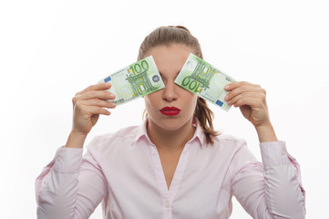 A woman closes her eyes with two money bills