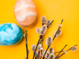 easter holidays postcard, colorful easter eggs and pussy willow branches on yellow background