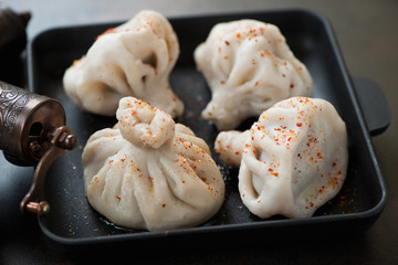 Close-up of khinkali or boiled georgian dumplings with meat stuffing, selective focus