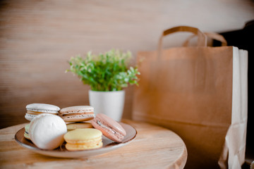 Kitchen plate with colorful macaroon. Wooden table