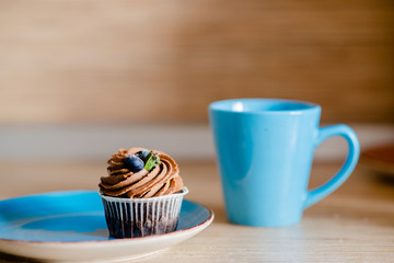decorated  tasty Cupcake with slice of Strawberry and Chocolate on the table. Horizontal view several objects