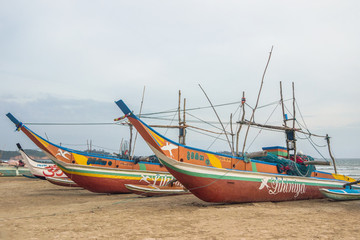 colorful wooden fishing boat on beach in Sri Lanka 