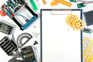Robot line tracking designing and assembling in above view with engineering tools, sensor and blank paper for note idea. Robot and microcontroller tools for make innovation.