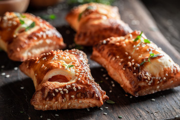 Delicious sausage in puff pastry with tatar sauce and herbs