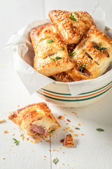 Fresh sausage in puff pastry with thyme and sesame seeds