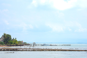 Speed boats moored at the wooden bridge and blue sky in the sea at Laem ngop Pier ,Trat in Thailand.