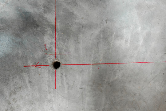 A Hole Is Drilled In The Concrete Wall Using The Markings.