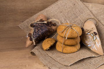 Oatmeal cookies  with handmade coffe heart on a old wooden background
