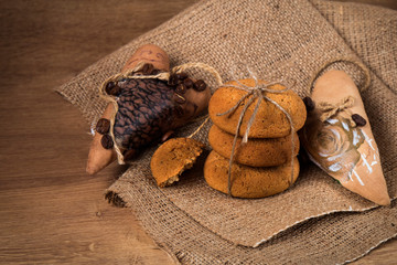 Oatmeal cookies  with handmade coffe heart on a old wooden background