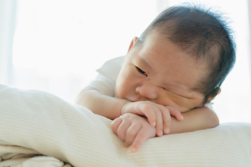 cute infant baby boy sleep with sweet dream and peaceful white soft bed