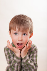 the boy is very surprised on white background