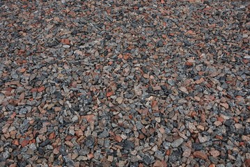 brown gray stone texture of fine wet rubble in a heap