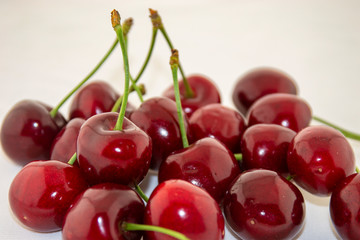 Red, ripe cherries on a white background