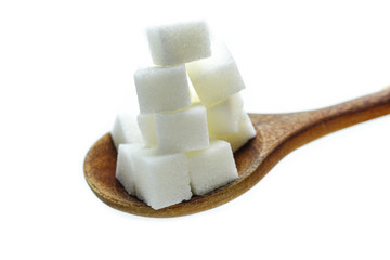Sugar sweet cubes high calories in wooden spoon : fat diet healthy food concept.