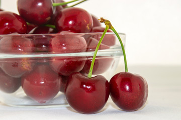 Red, ripe cherries on a white background