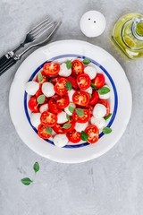 Caprese Italian salad with tomato, mozzarella and basil. Top view