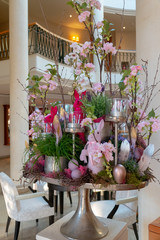 an artfully arranged Easter arrangement stands in the foyer of a hotel