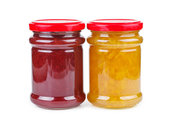 Glass jars with peach and strawberry jam on white background