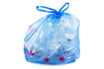 Blue plastic garbage bag with used PET bottles isolated on white background