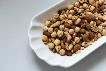 a plate full of nuts, cashews, almonds dry, close-up